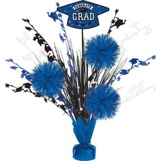 a blue vase filled with flowers and graduation cap on top of it's head