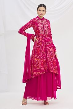 Magenta asymmetric kurta with Bandhani print and embroidered bodice. Paired with palazzo and dupatta.
Component: 3
Printed
Neckline: Mandarin
Sleeve Length: Full
Fabric: Georgette
Color: Pink
Embroidered bodice
Back cutout - Aza Fashions Bandhani Lehenga, Asymmetric Kurta, Bandhani Print, Bandhani Dress, Kurta Set For Women, Long Skirt Outfits, Kurti Designs Latest, Embroidered Bodice, Stylish Party Dresses