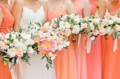 the bridesmaids are holding their bouquets in orange and pink dresses with white flowers