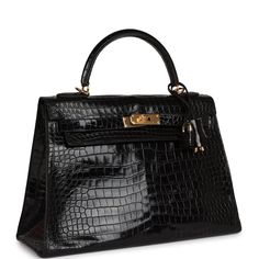 This Kelly is in Black shiny porosus crocodile with gold hardware and features tonal stitching, a front toggle closure, a clochette with lock and two keys and a single rolled handle.The interior is lined with black chevre and features one zip pocket with an Hermes engraved pull and two open pockets on the opposite side.Collection: Illegible Origin: FranceCondition: Vintage; Excellent - This bag's structure is slightly relaxed on the side near the pull straps and to the back exterior near the sid Hermes Kelly Sellier, Kelly 32, Kelly Sellier, Handbag Collection, Vintage Hermes, Crocodile Skin, Luxury Bag, Hermes Bags, Black Excellence