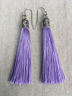 Chic light purple tassel earrings!  They would add a pop of color to any outfit for any occasion.  Dress them up or down.  They are timeless and versatile.  They are lightweight, fun and unique!The tassels measure 2 1/8” long by 1/4” wide.  They hang from simple silver ear wire hooks.  Overall drop length is about 2 1/4”.  Metal is allergy free plated silver.These are my latest creation!  I have them available in many colors!  Find them all under the category tassel earrings in my shop.Thanks fo Bohemian Purple Tassel Earrings, Elegant Purple Tassel Earrings, Bohemian Purple Dangle Tassel Earrings, Adjustable Purple Bohemian Tassel Earrings, Purple Dangle Tassel Jewelry, Handmade Purple Tassel Earrings As Gift, Handmade Purple Tassel Earrings For Gift, Purple Dangle Jewelry With Tassels, Purple Fringe Tassel Earrings Gift