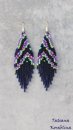 two pairs of beaded earrings with fringes and beads on the bottom, one is purple