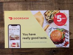 the doordash coup card is displayed on a wooden table next to an iphone