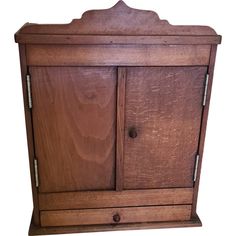 an old wooden cabinet with two doors on one side and three drawers on the other