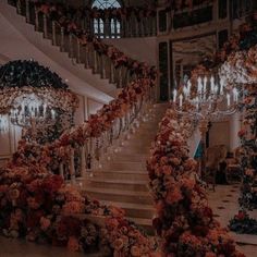 an elaborate staircase decorated with flowers and chandeliers