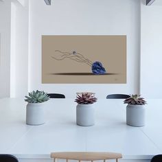 a table with four chairs and two vases filled with succulents on it