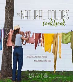 the natural colors cookbook is shown with a woman hanging clothes on a line in front of a tree