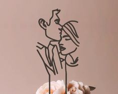 a wedding cake with a couple kissing on top