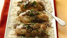 chicken with mushrooms and white rice on a red table cloth next to a spoon in it