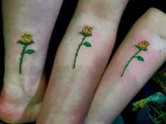 two people with matching tattoos on their feet and one has a yellow rose tattooed on the left leg