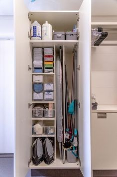 an organized closet is shown with shoes and other items in it, including cleaning supplies