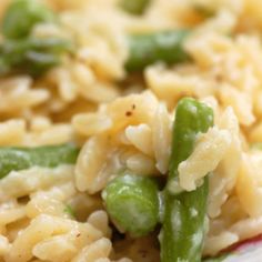 pasta with peas and green beans on a red and white striped dish cloth, ready to be eaten