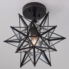 a light that is on the ceiling with a star shaped light fixture in front of it