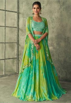 Readymade Faux Georgette Lehenga in Sea Green and Yellow This attire with Poly Shantoon Lining is Enhanced with Resham, Zari, Sequins, Mirror and Patch Border Work Available with a Art Silk Sea Green Sleeveless Choli Crafted in Round Neckand a Jacket Style Faux Georgette Dupatta. The Choli, Jacket and Lehenga Lengths are 16 to 17, 38 and 44 inches respectively Do Note: Accessories shown in the image are for presentation purposes only. (Slight variation in actual color vs. image is possible). Party Wear Skirt Top, Mehandi Outfits, Mehendi Outfit, Haldi Outfits, Cocktail Skirts, Mehendi Outfits, Georgette Lehenga, Yellow Lehenga, Lehenga Designs Simple