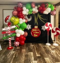 the balloon arch is decorated with candy canes, lollipops and christmas decorations