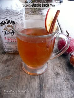 an apple cider with cinnamon and apples on the side