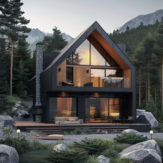 a modern house in the woods with large rocks and pine trees around it, at dusk