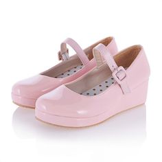 a pair of pink shoes on top of a white surface