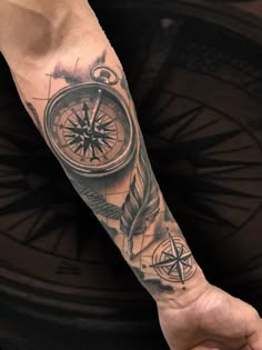 a man with a compass tattoo on his arm