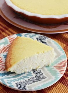 a piece of cake on a plate next to a bowl with the rest of it