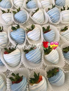 there are many chocolate covered strawberries in the trays with strawberry decorations on them