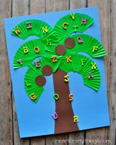 a palm tree made out of paper with letters on it