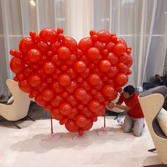 a large heart shaped balloon sitting on top of a table