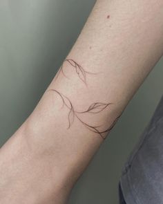 a person's arm with a small tattoo on the left side of their arm