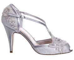 a women's silver high heeled shoe with flowers on the side and straps