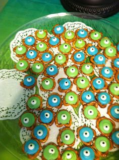 there is a plate with cookies decorated like an owl on it and lace doily