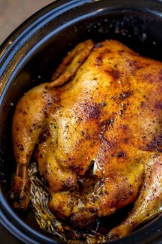 a cooked chicken in a slow cooker