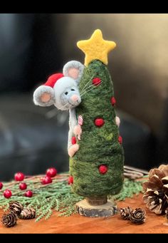 a small christmas tree with two mice on it