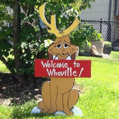 a cardboard sign that says welcome to whovillee with a deer's head on it