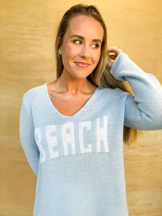 Get cozy with this beachy light blue sweater. Featuring a playful white print that reads "beach," this sweater is perfect for lounging by the ocean or just adding some seaside vibes to your look. Stay warm and stylish with this quirky piece! Ashley is 5'4" and is wearing a size medium. Beach Sweater, By The Ocean, Light Blue Sweater, Blue Sweater, Getting Cozy, Sweater Blouse, Clothes Collection, Dress Romper, Blue Sweaters