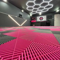 a large room with pink and grey flooring