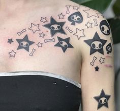 a woman's shoulder with skulls and stars on it