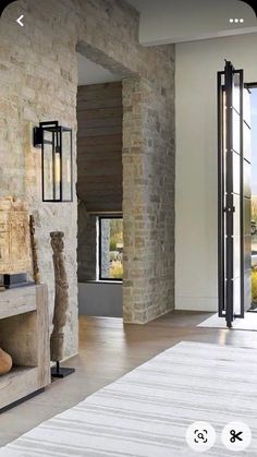 a living room with stone walls and flooring