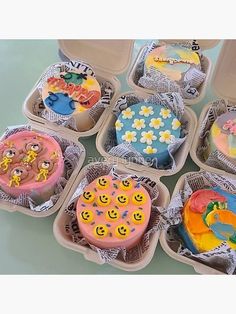 six cupcakes in plastic containers with smiley faces on them