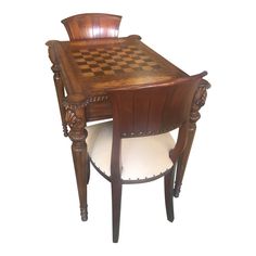 a wooden table and chair with chess board on the backrest, against a white background