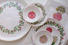 a table topped with plates and bowls covered in christmas decorations on top of each other