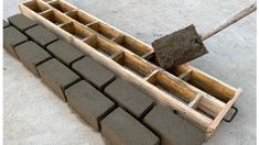 a piece of wood sitting on top of cement blocks