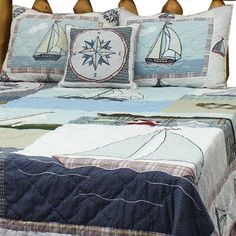 a bed with two pillows on top of it and a quilted comforter in the middle