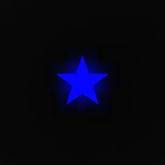 a blue star is lit up in the dark