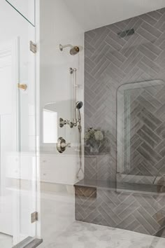 a bathroom with a glass shower door next to a sink