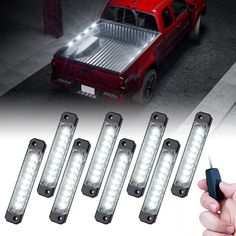 four white lights on the front of a red pickup truck and five black leds