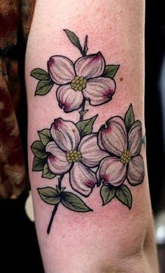 a woman's arm with flowers on it