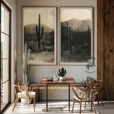 two paintings hang on the wall above a dining room table with chairs and a cactus