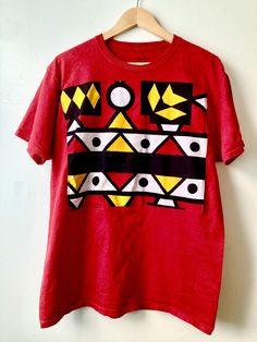 African print mens tshirt  Samakaka print appliqueed onto front Red Cotton Shirt With Graphic Print, Unisex Red Cotton T-shirt, Unisex Pre-shrunk Red T-shirt, Unisex Red Screen Print Tops, Red Cotton Shirt With Sublimation Print, Red Cotton Top With Sublimation Print, Red Printed T-shirt For Streetwear, Red Printed Cotton T-shirt, Red Cotton Printed T-shirt