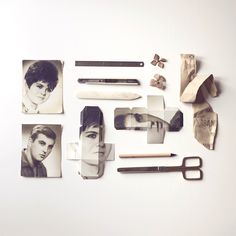 various photographs and scissors are arranged on a white surface