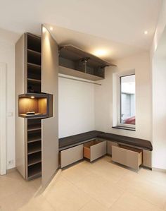 an empty room with built in shelving units